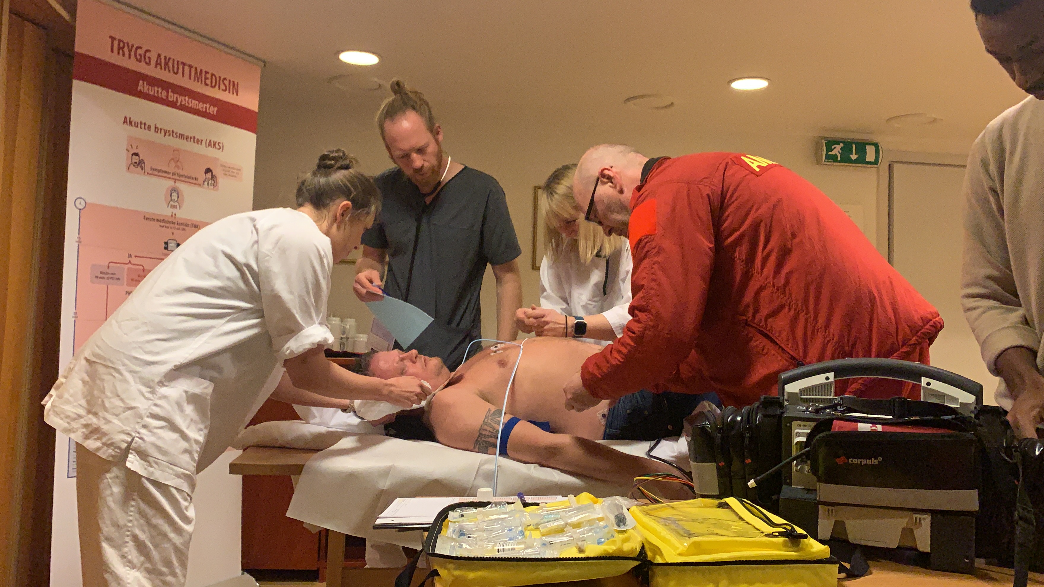 A group of people attending to a patient