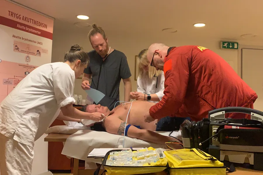 A group of people attending to a patient