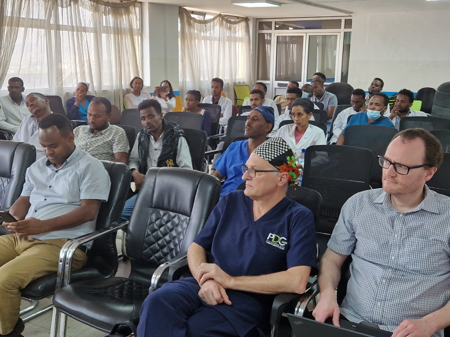 A group of people sitting in chairs