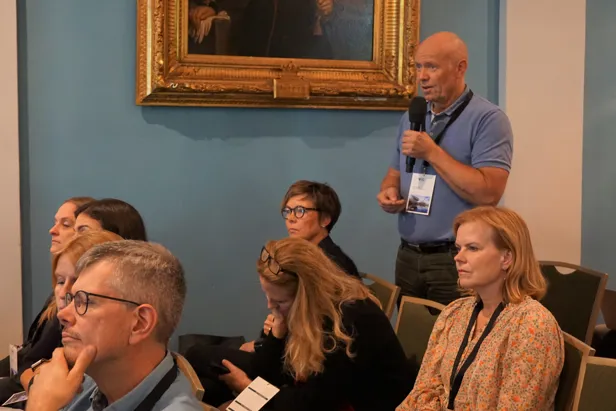 A man speaking to a group of people