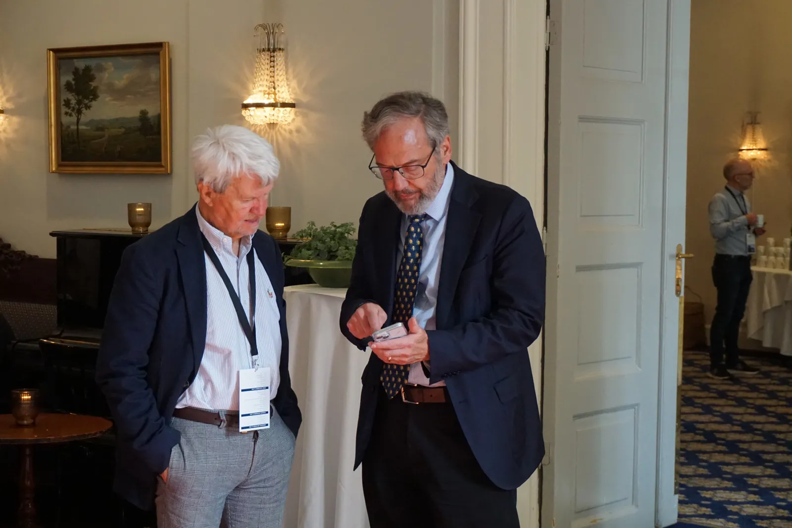 A man and a woman looking at a cell phone