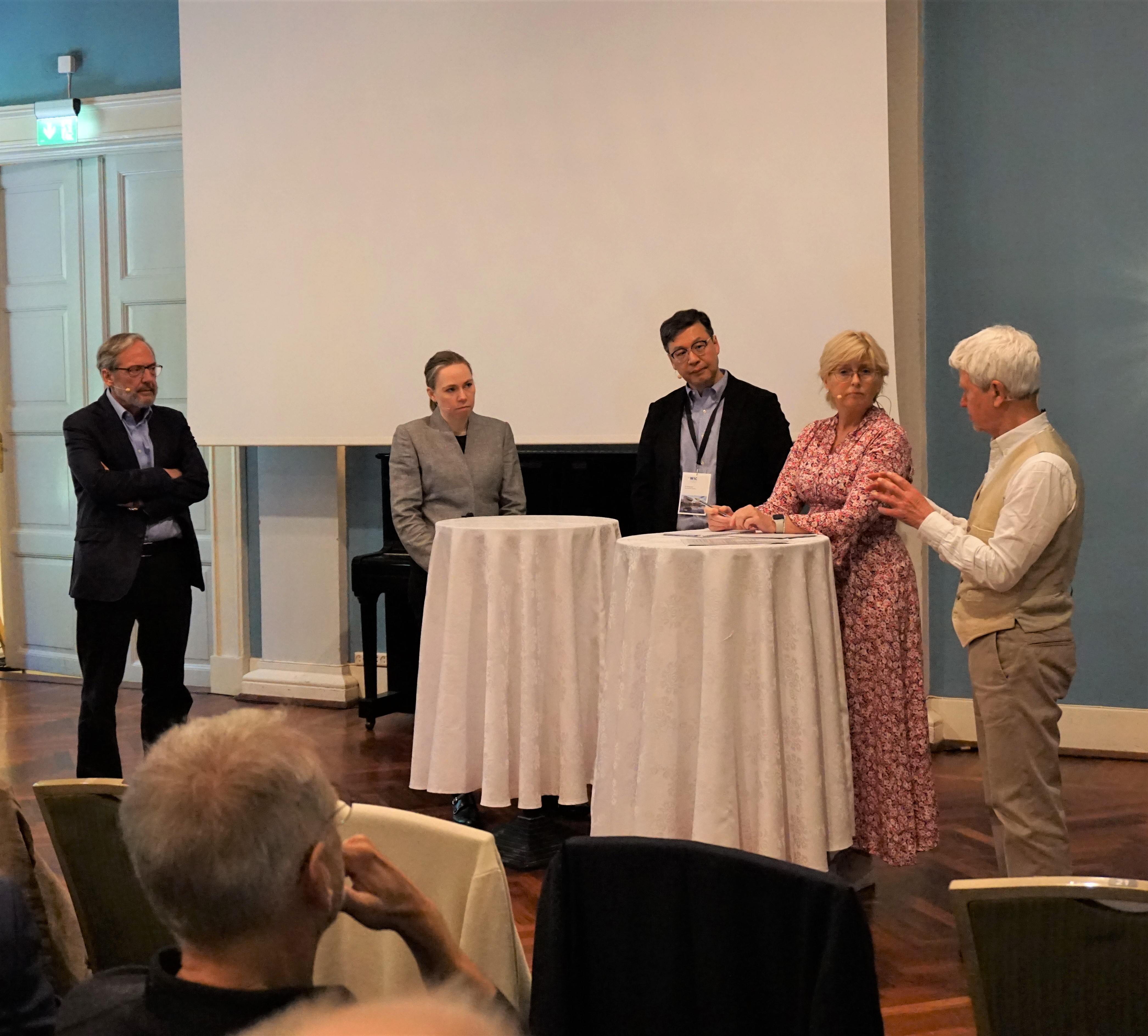 A group of people standing around a table