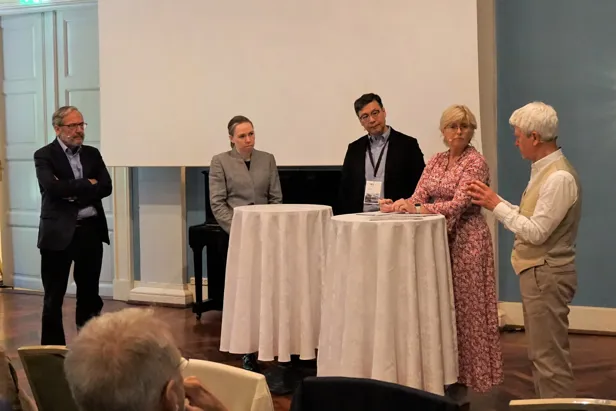 A group of people standing around a table