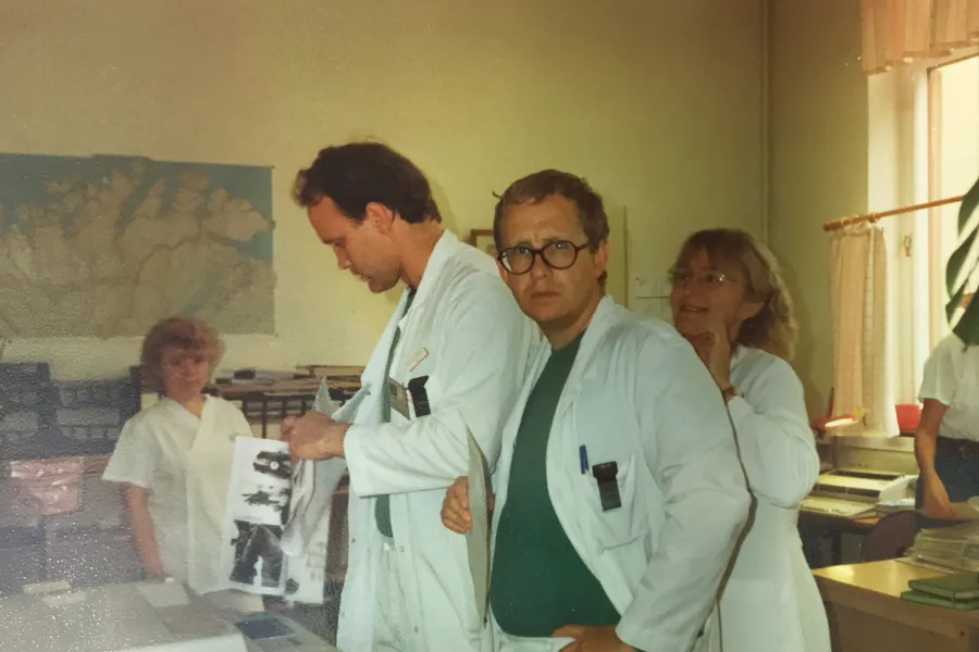 A group of people looking at a piece of paper