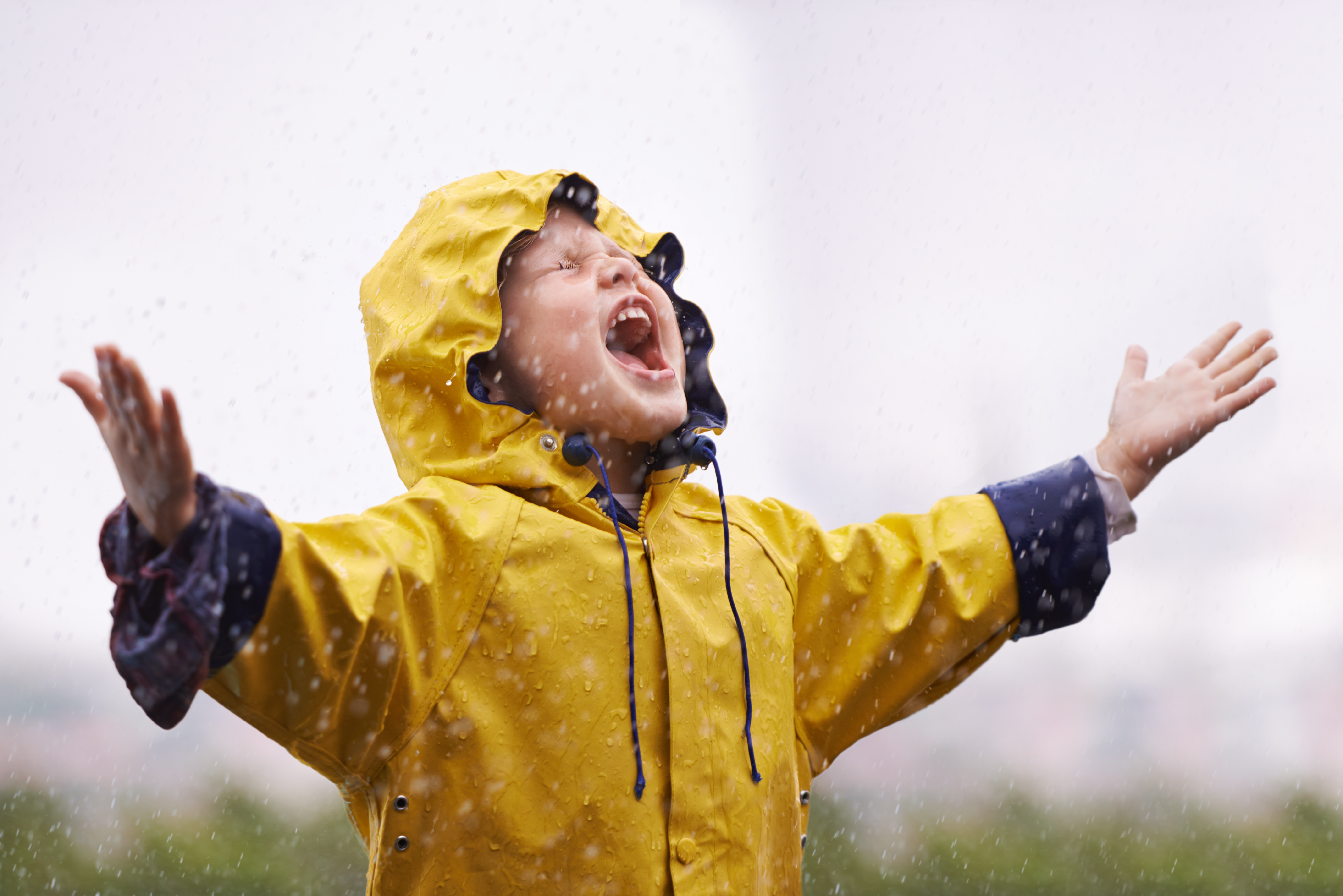 A girl wearing a yellow raincoat