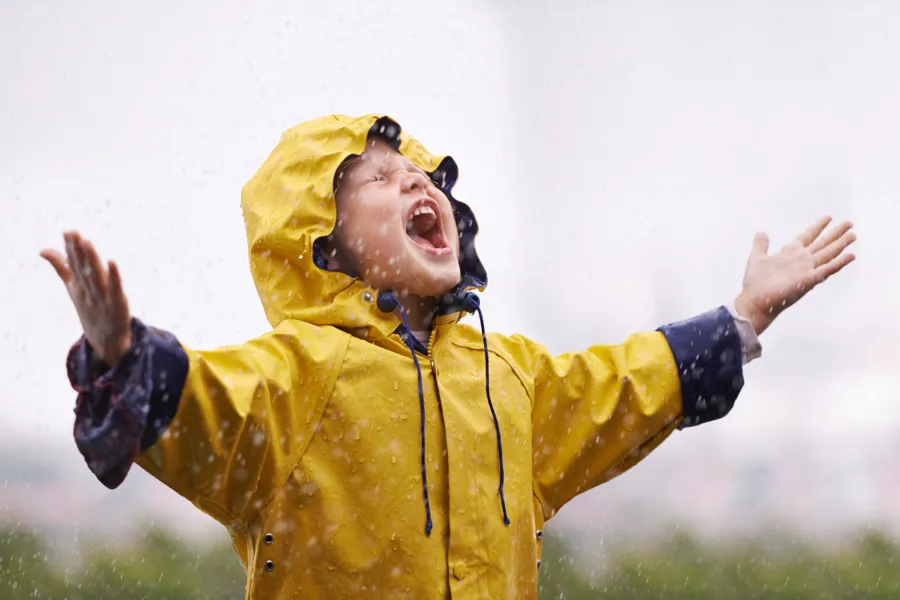 A girl wearing a yellow raincoat