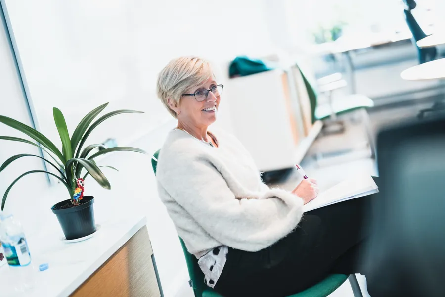 Eva Stensland sitting at a desk